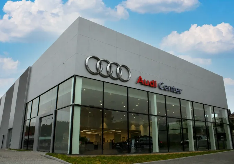 Fachada de vidro de uma concessionária Audi Center com os quatro anéis na parte superior