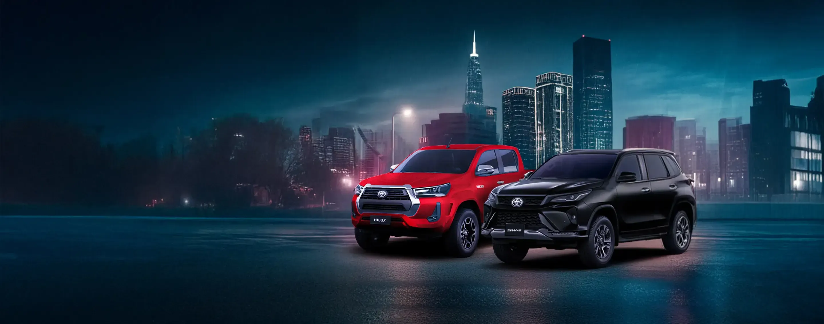 Dois carros Toyota em uma cidade a noite