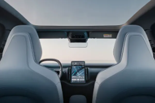 Interior de um Volvo com bancos azul-claros, tela central e teto solar